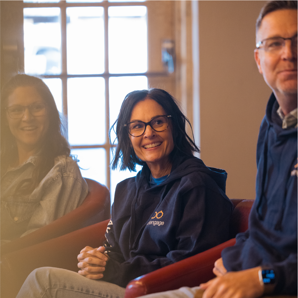 Photo of 2 women and 1 men smiling while meeting